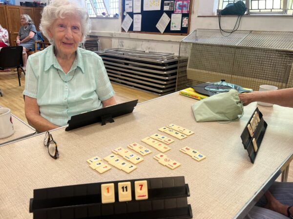 Person playing a game with tiles
